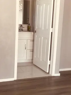 an open door to a bathroom with a sink at Noah Unit - B in Hawthorne
