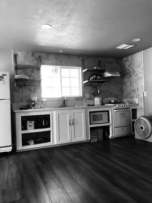 a kitchen with white cabinets and a stove top oven at Noah Unit - B in Hawthorne