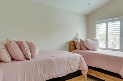 a bedroom with two beds with pink pillows and a window at 2 Mi to Promenade at Westlake Mtn-View Haven! in Westlake Village