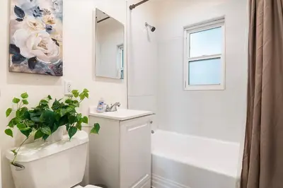 a bathroom with a toilet and a sink and a mirror at Ground-Floor 1-Bedroom by Beverly Hills Steps from Restaurants, Cafes and Shopping in Los Angeles
