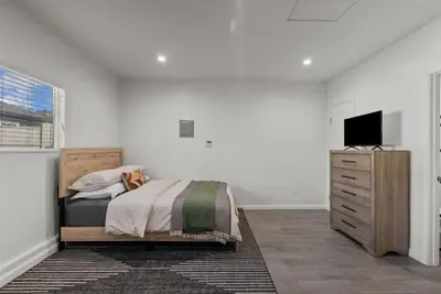 a bedroom with a bed and a dresser with a television at Charming Valley Village Studio Retreat in Los Angeles