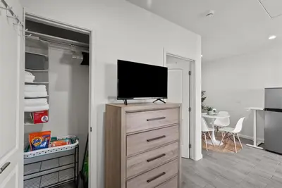 a living room with a tv on a dresser at Charming Valley Village Studio Retreat in Los Angeles
