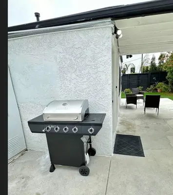 a barbecue grill in a backyard with a patio at Modern Studio Stylish &Cozy Right Unit in Los Angeles