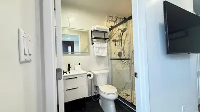 a bathroom with a toilet and a sink and a shower at Modern Studio Stylish &Cozy Right Unit in Los Angeles