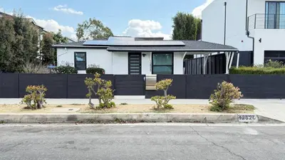 a white house with a black fence at Modern Studio Stylish &Cozy Right Unit in Los Angeles