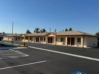 an empty parking lot in front of a building at Dutch Motel in Loma Linda