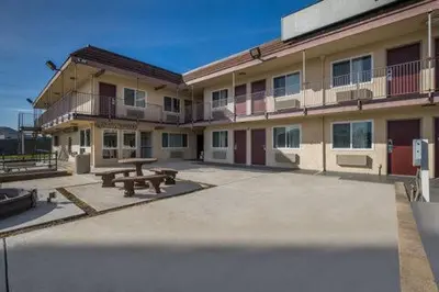 a building with a picnic table in front of it at Rodeway Inn San Bernardino and Redlands in San Bernardino