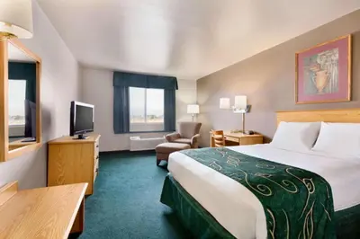 a hotel room with a bed and a television at Travelodge by Wyndham Yermo in Yermo