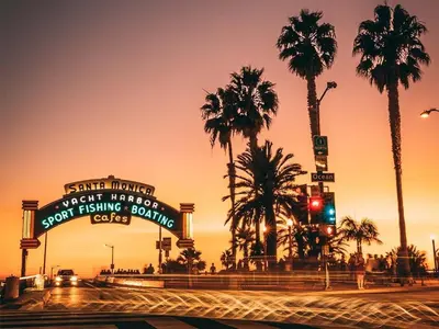 a street with palm trees and a traffic light at Modern 2BD - 5 min to Santa Monica Pier! in Los Angeles