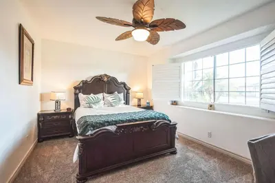 a bedroom with a bed and a ceiling fan at Peaceful Oasis in Anaheim