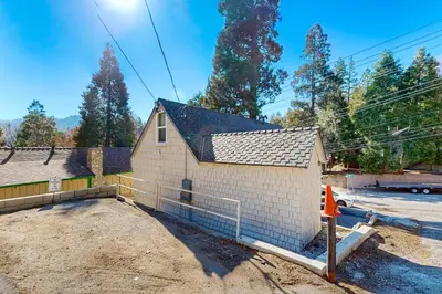 a house under construction with a fence around it at Relaxing Retreat with Deck, 1 Mi to Lake Arrowhead! in Cedar Glen