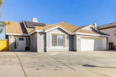 a large white house with a garage at 10 Mi to Mojave Narrows Victorville Studio in Victorville