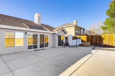 a house with a large patio with a fence at 10 Mi to Mojave Narrows Victorville Studio in Victorville