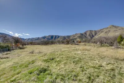 a field of grass with mountains in the background at Lake and Mountain Views Cozy California Stay in Mountain Mesa