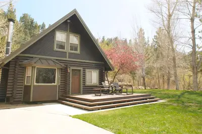 a small cabin with a picnic table in front of it at Bear Creek Haven -Nestled between the Village & Lake! in Big Bear Lake