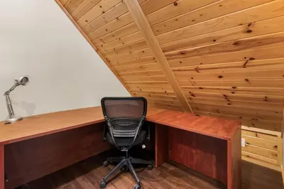 a desk with a chair in a room with wooden ceilings at Bear Creek Haven -Nestled between the Village & Lake! in Big Bear Lake