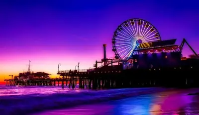 a ferris wheel on the beach next to a pier at Santa Monica Bright Studio with stunning view in Los Angeles