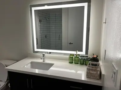 a bathroom sink with a large mirror above it at Santa Monica Bright Studio with stunning view in Los Angeles