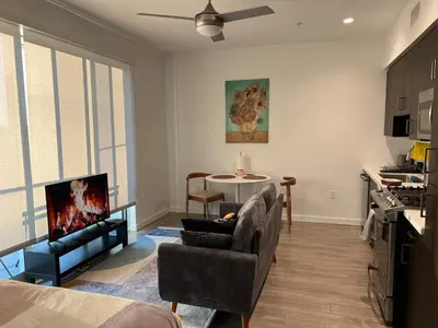 a living room with a couch and a chair and a table at Santa Monica Bright Studio with stunning view in Los Angeles