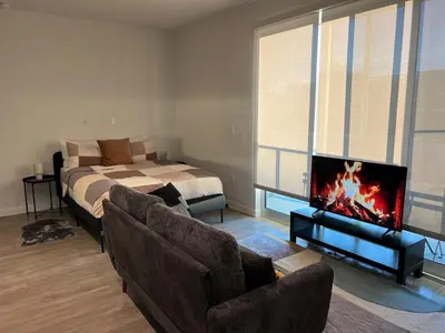 a living room with a bed and a couch and a tv at Santa Monica Bright Studio with stunning view in Los Angeles