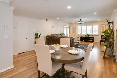 a dining room and living room with a table and chairs at 10 Mi to Redondo Beach Carson Home with Pool Table! in Carson