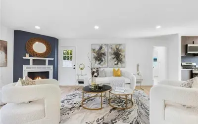 a living room with white furniture and a fireplace at cozy house 4 bedrooms 2 baths in Glendora