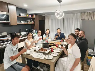 a group of people sitting around a table eating food at cozy house 4 bedrooms 2 baths in Glendora