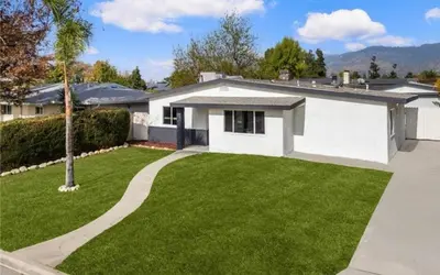 a white house with a green yard at cozy house 4 bedrooms 2 baths in Glendora