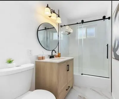 a bathroom with a toilet and a sink and a mirror at cozy house 4 bedrooms 2 baths in Glendora