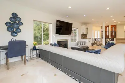 a large couch in a living room with a fireplace at Luxury Modern w/ Great LA Views in Woodland Hills