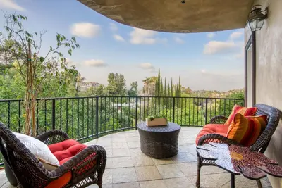 a patio with two chairs and a balcony with a view at Luxury Modern w/ Great LA Views in Woodland Hills