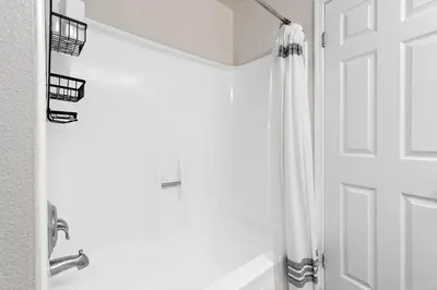 a bathroom with a shower and a white door at A Symphony of Blue - Panoramic Ocean Frontage - 3BR Marina Suite in Los Angeles