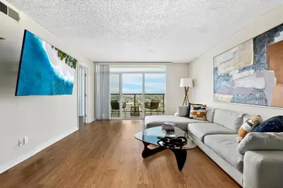 a living room with a couch and a table at A Symphony of Blue - Panoramic Ocean Frontage - 3BR Marina Suite in Los Angeles