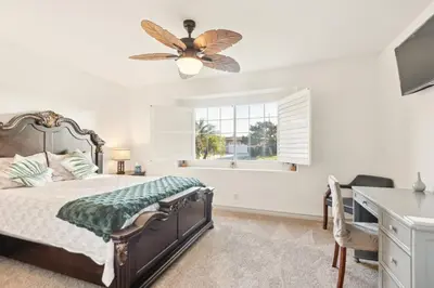 a bedroom with a bed and a desk and a window at Family Oasis in Anaheim