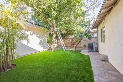 a green yard with a tree in a house at Family Oasis in Anaheim