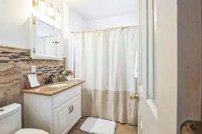 a bathroom with a sink and a toilet and a shower at Family Oasis in Anaheim