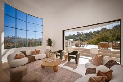 a living room with two couches and a large window at Woodhill Canyon in Los Angeles