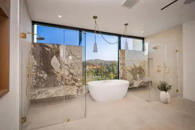 a bathroom with a tub and a glass shower at Woodhill Canyon in Los Angeles
