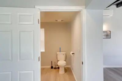 a bathroom with a toilet and a door at 6 Mi to Frazier Mountain Cozy Studio Retreat in Frazier Park