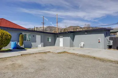 a gray building with a white chair in a driveway at 6 Mi to Frazier Mountain Cozy Studio Retreat in Frazier Park