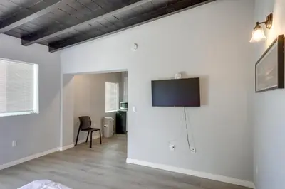 a living room with a flat screen tv on a wall at 6 Mi to Frazier Mountain Cozy Studio Retreat in Frazier Park