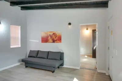 a living room with a chair and a painting on the wall at 6 Mi to Hiking Apartment in Frazier Park in Frazier Park