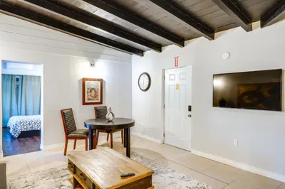 a living room with a table and a tv at Hike and Explore Studio Stay in Frazier Park in Frazier Park