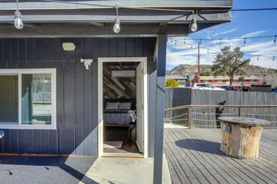 a black house with a bed on a deck at Private Deck and Views Frazier Mountain Cabin in Frazier Park