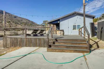 a house with a deck with a green hose at Private Deck and Views Frazier Mountain Cabin in Frazier Park