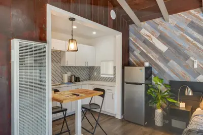 a kitchen with a table and a refrigerator at Private Deck and Views Frazier Mountain Cabin in Frazier Park