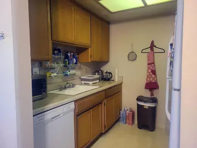 a kitchen with wooden cabinets and a sink at Guest Room in Sherman Oaks with private bathroom and balcony in Sherman Oaks