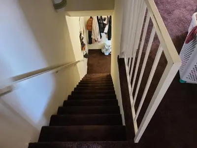 a stairway leading up to a room with purple carpet at Guest Room in Sherman Oaks with private bathroom and balcony in Sherman Oaks