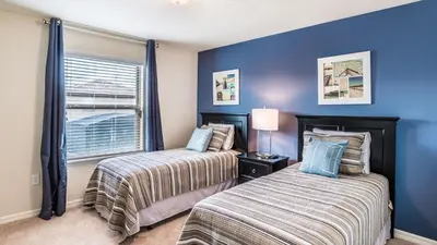 two beds in a bedroom with blue walls and a window at ROM2112 in Los Angeles