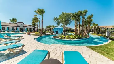 a swimming pool with blue lounge chairs and palm trees at ROM2112 in Los Angeles